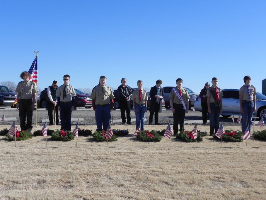 Boy Scouts mark the ceremonial wreaths for Army, Navy, Marines, Air Force, Coast Guard, Merchant Marine and POW