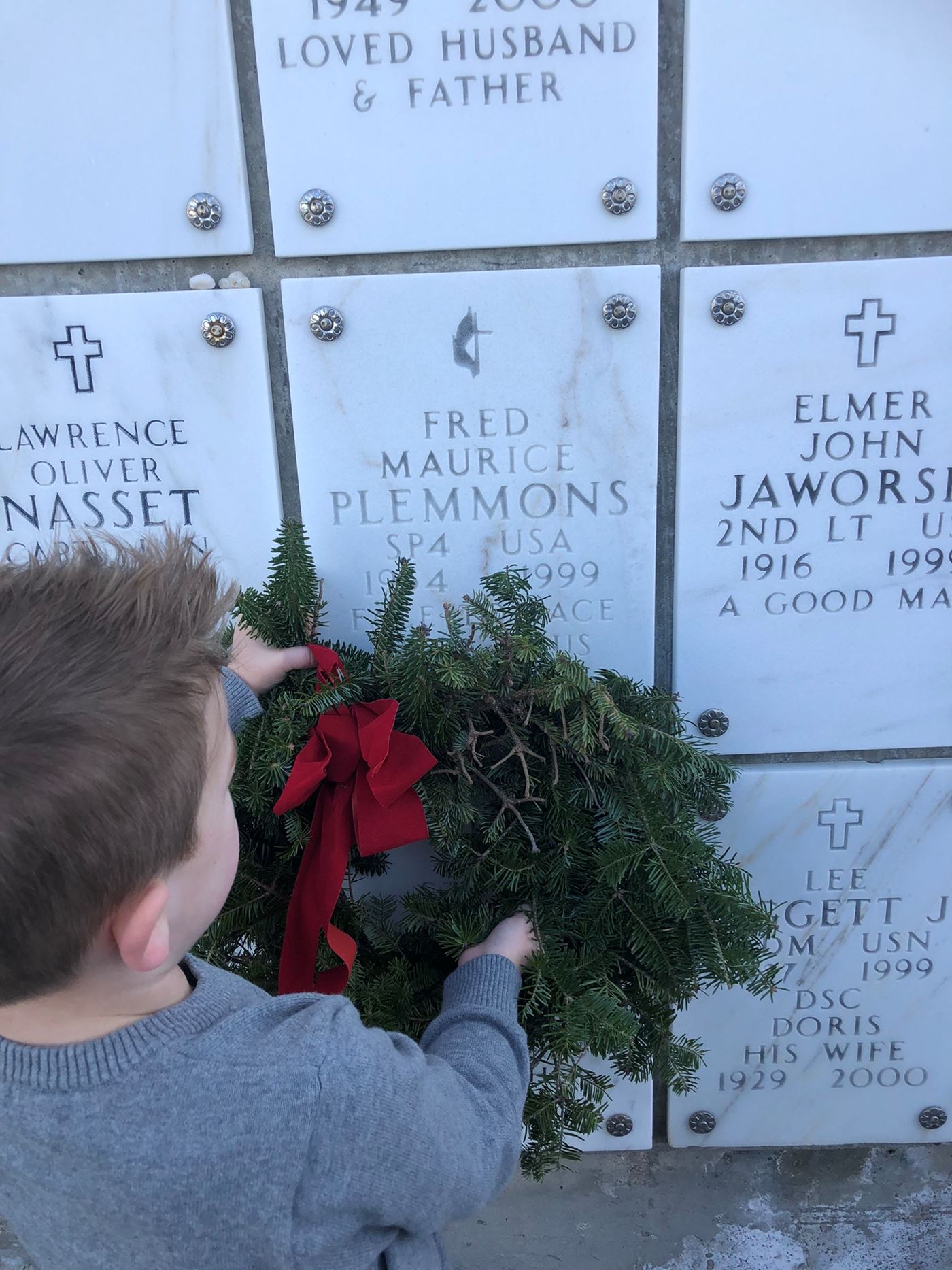 Mason Moore places a wreath at the grave of his great uncle Maurice Plemmons at Fort Rosecrans National Cemetery 2022.