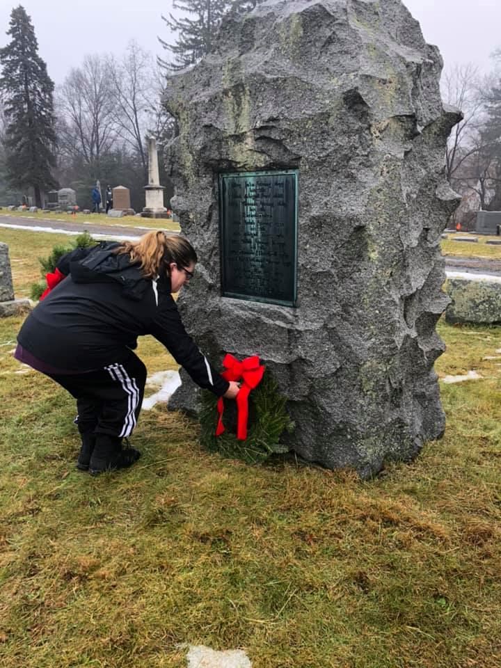 Quassaick DAR member Colleen McArdelle placing a wreath at the Strong family monument in 2019