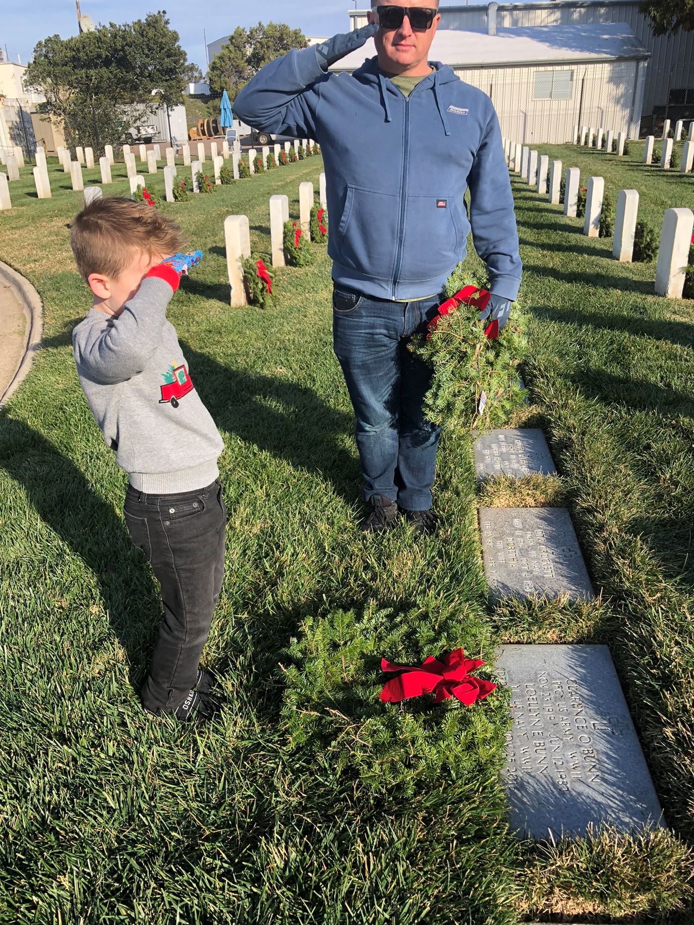 Jeb Moore and son Mason Moore assist the Desert Palm Chapter in laying grave-specific wreaths at Fort Rosecrans National Cemetery 2022.