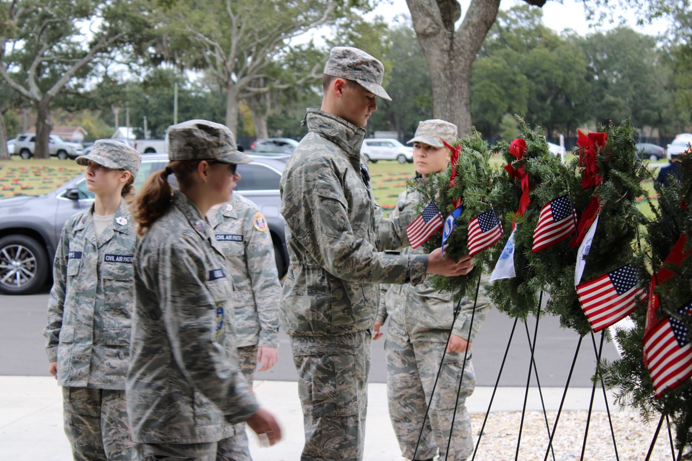 Cadets carefully place a wreath, paying tribute to the memory of fallen heroes with utmost respect.