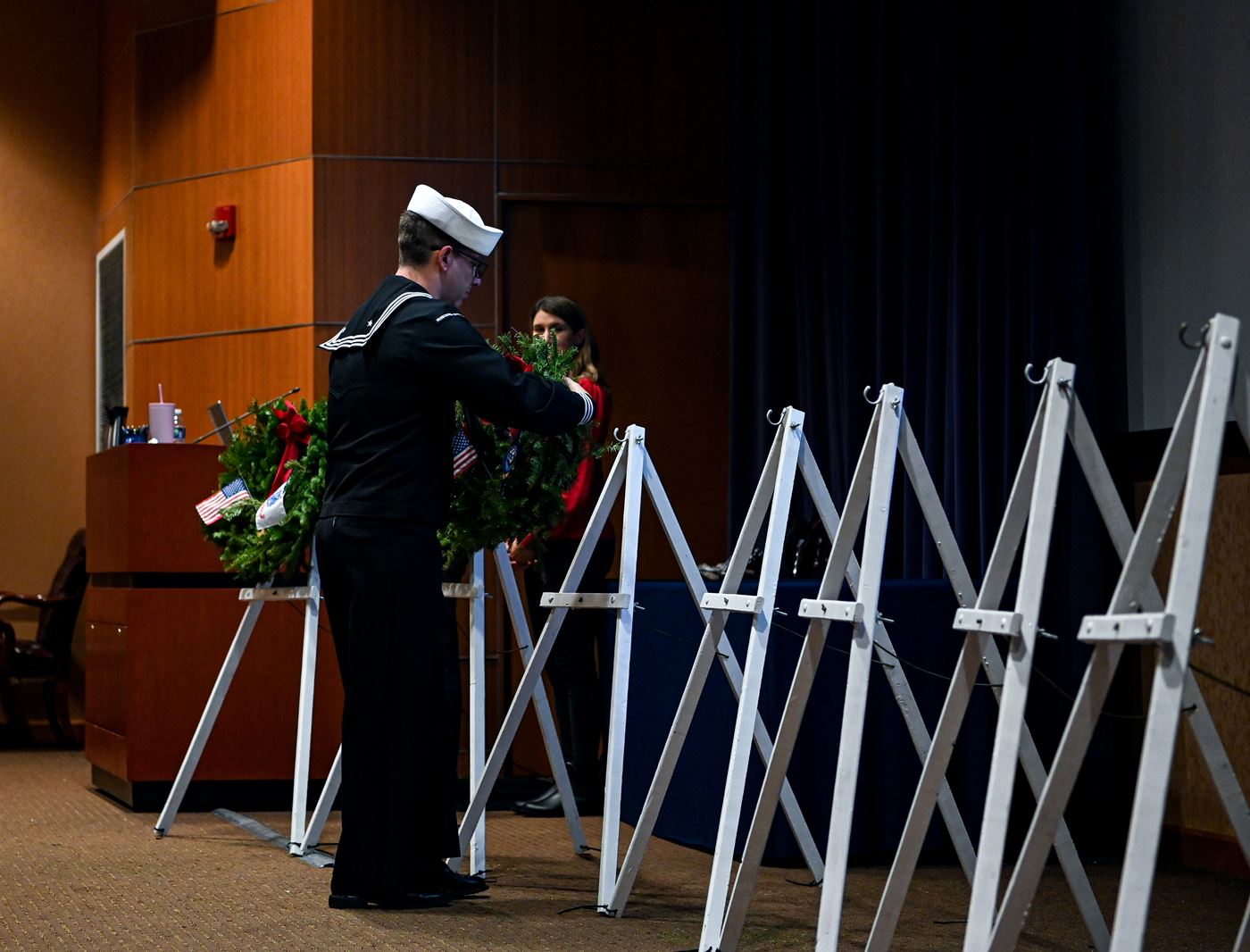 Petty Officer 1st Class Raymond Fenton places the veteran's wreath for those who served and are serving in the United States Navy