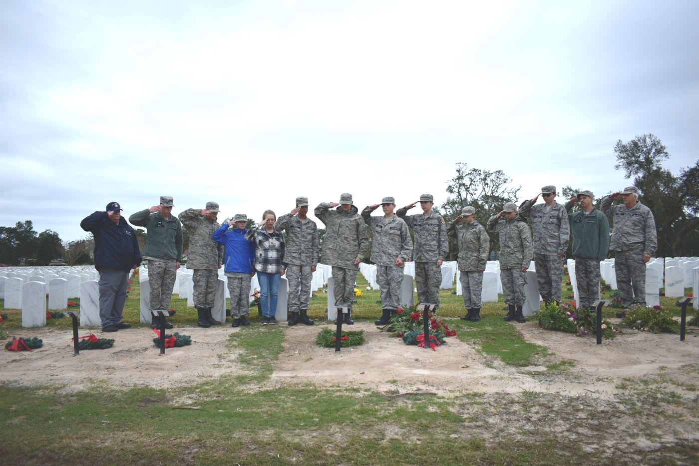 With determination and respect, cadets braved the elements to lay wreaths on the graves of fallen heroes at Biloxi National Cemetery.