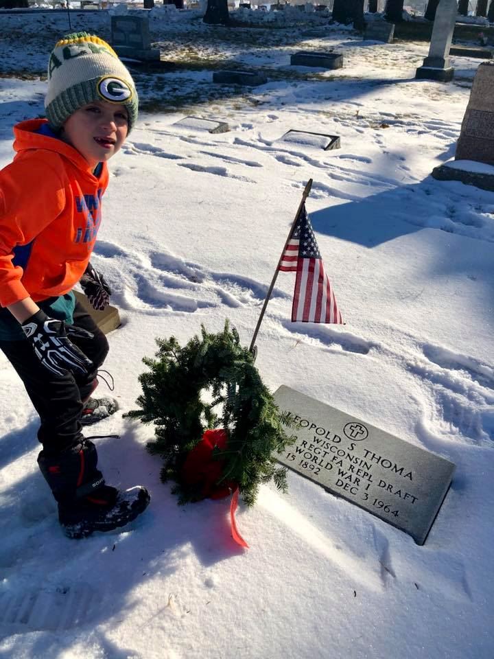 Reed places wreath on his great great great  uncle's grave.