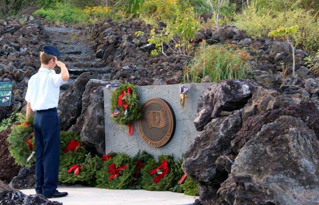 C/Amn Gallo saluting the POW/MIA memorial wreath.