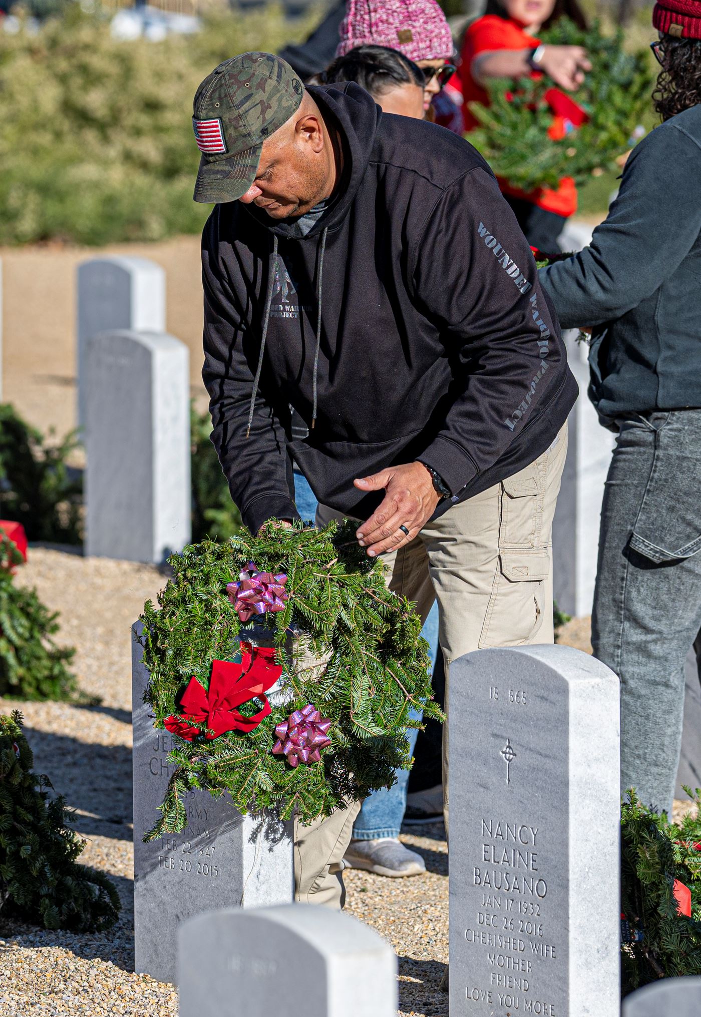 2023 WAA Day - Volunteer laying a wreath<br>