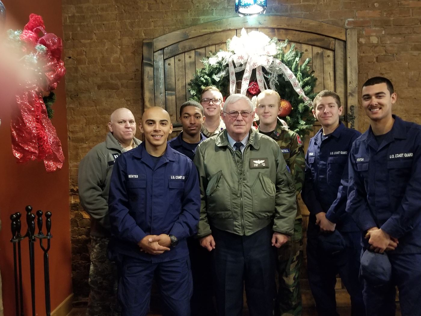 Members of Everette Stewart Civil Air Patrol Squadron and Coast Guardsmen stationed at US Coast Guard Station Hickman, KY, exchange stories and enjoy a meal together.