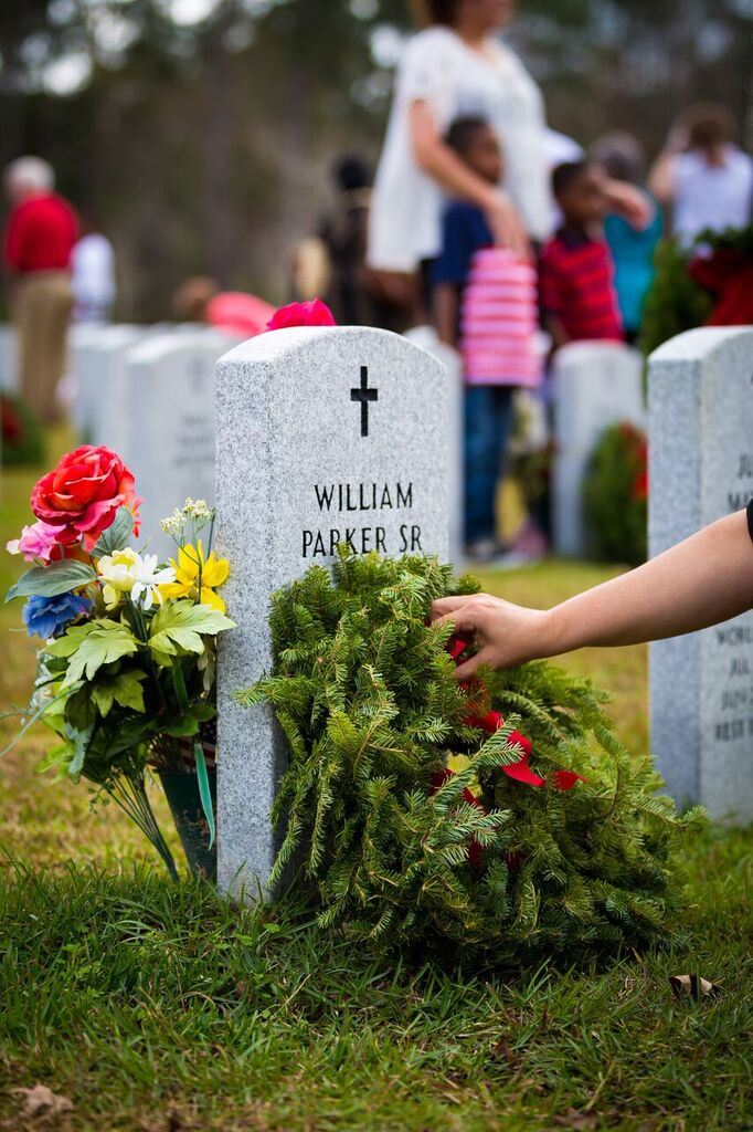 Volunteers place a wreath on every grave as they say the name of the veteran and honor their service.