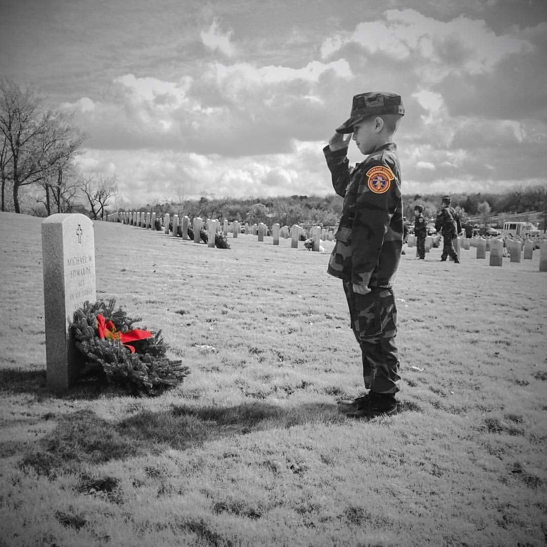 A Tarrant County Young Marine from Ft. Worth, Texas showing respect after laying a wreath at Dallas-Ft Worth National Cemetery 