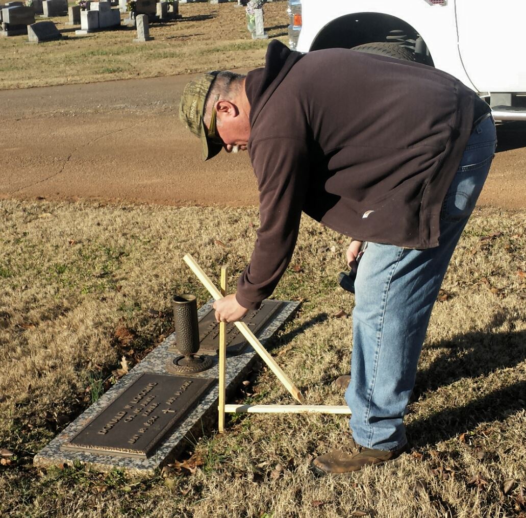 Veterans prepare cemetery to receive veteran wreaths.