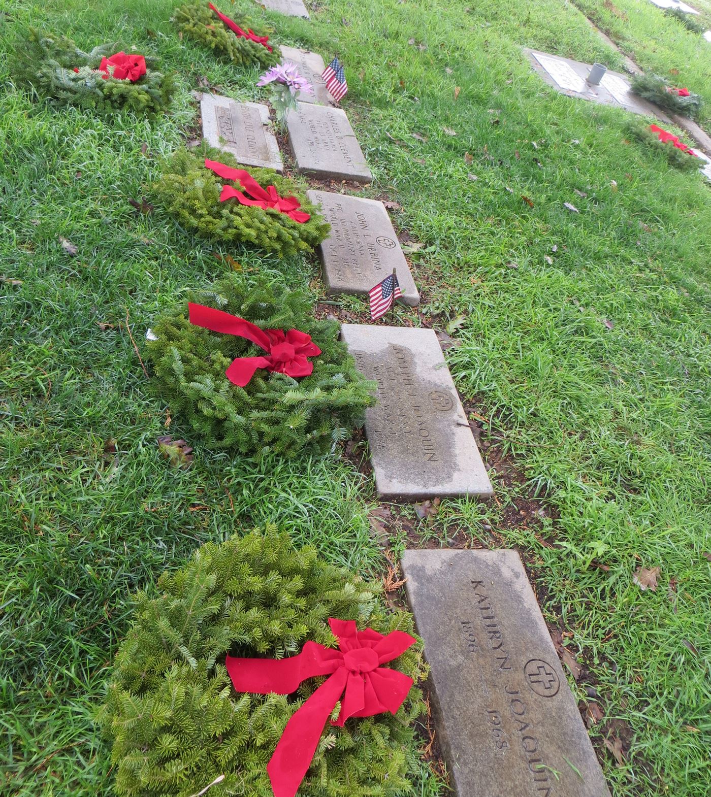 Wreaths laid on a row of many veteran gravesites.  Mt. Hope Cemetery, Morgan Hill, California