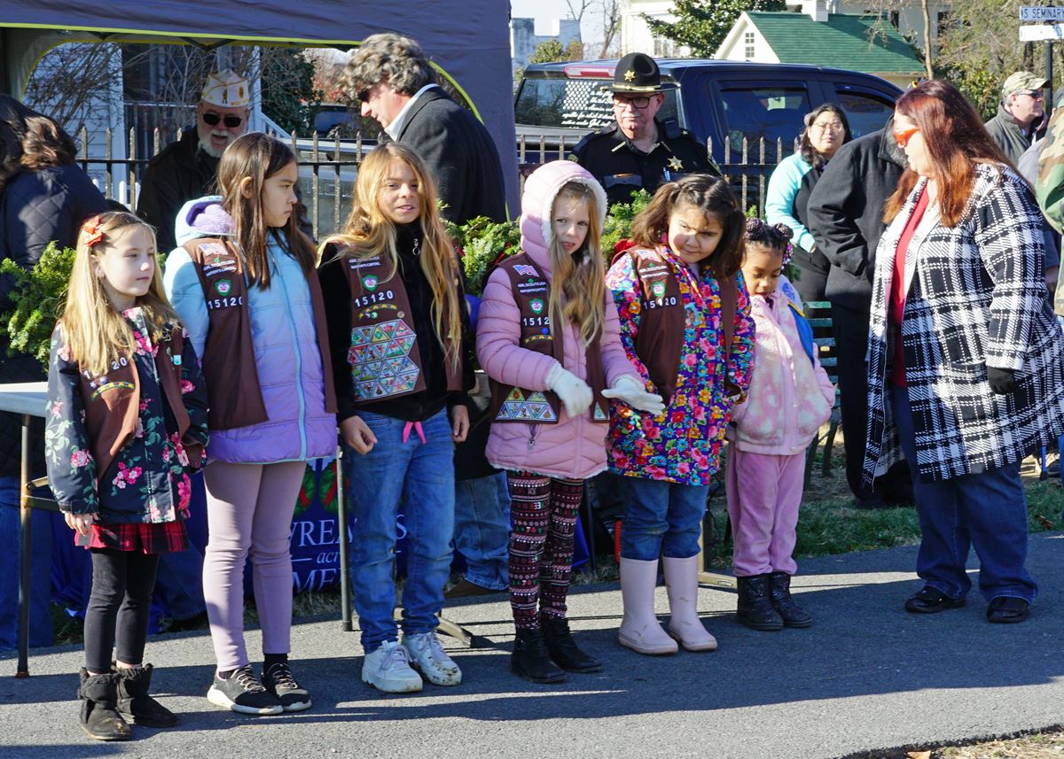 Girl Scout Troop 15120 gets ready to lead the attendees in the Pledge of Allegiance.