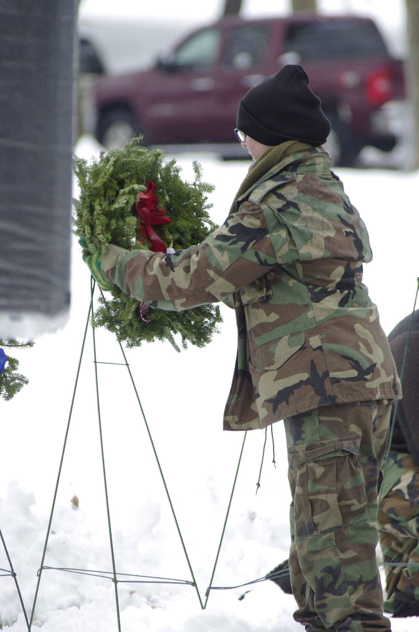 A Royal Charter Composite Squadron, Civil Air Patrol, US Air Force Auxiliary Cadet places a wreath in honor of one of six US Military Branch?es.