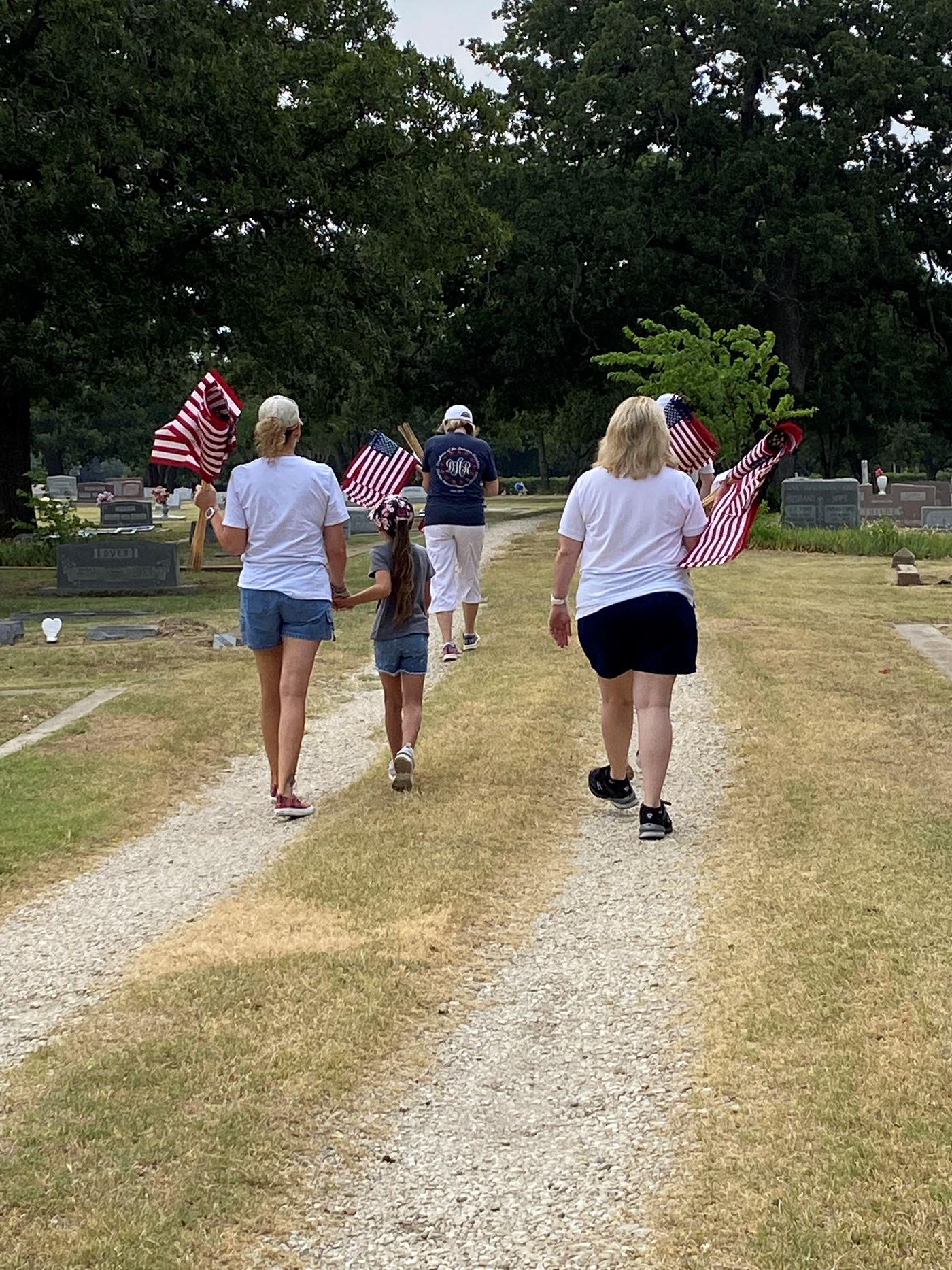 Members of The Flower Mound Chapter NSDAR and children on a mission to remember, honor and teach about the service and sacrifice of our local veterans by placing Memorial Day flags.