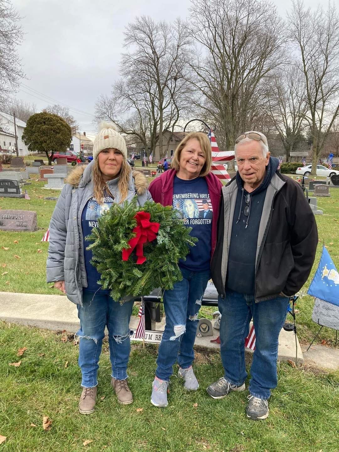 Family gathers to honor their veteran with Grave Specific Wreath.<br>