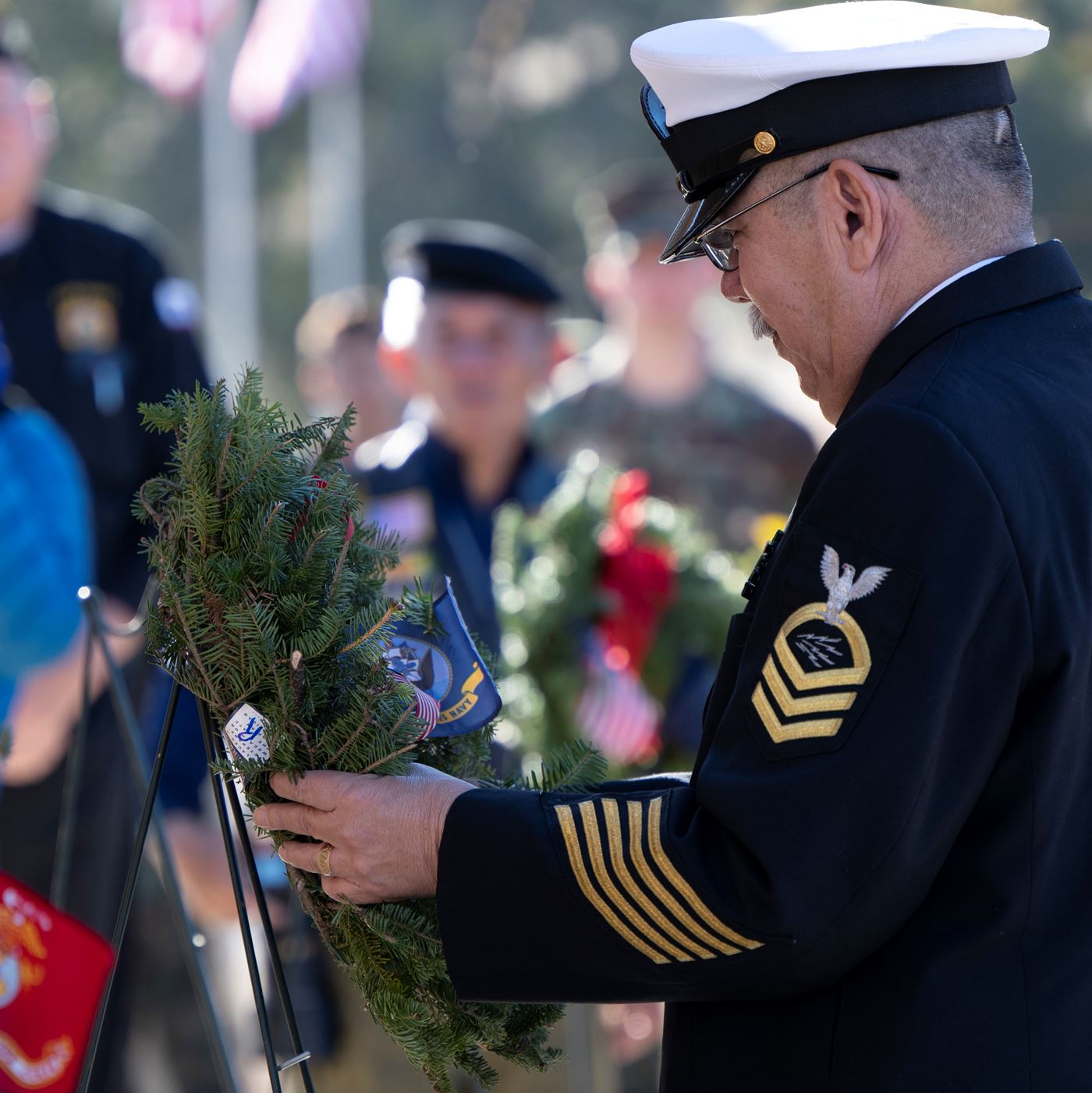 Retired Navy Chief Petty Officer Ricardo Ybarra laying the wreath in memory of those who served and are serving in the United States Navy<br>