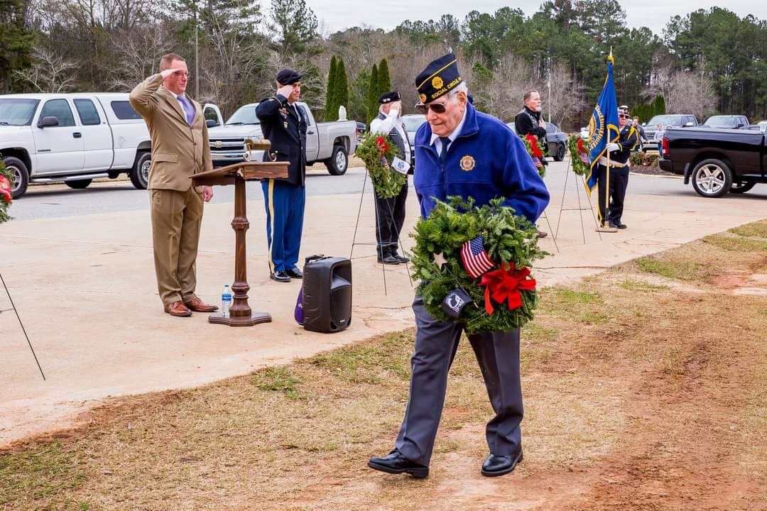 Retired Colonel William Harrington places the POW Wreath.