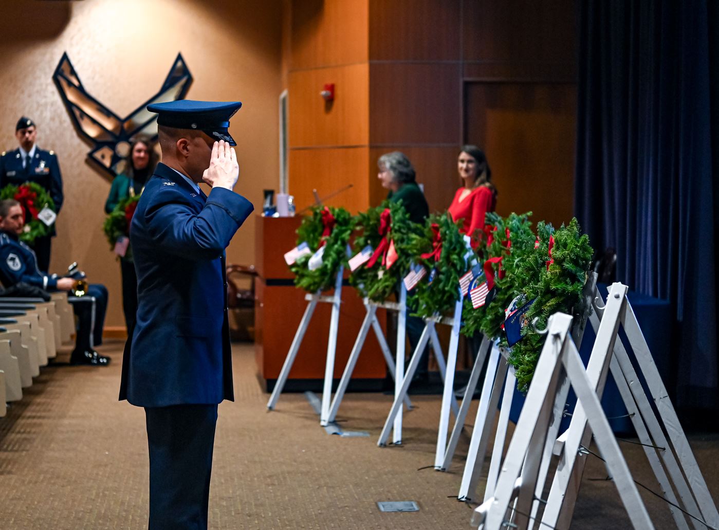 Col. Aaron Gray, 55th Wing deputy commander, salutes veteran's wreath for the United States Merchant Marines&nbsp;