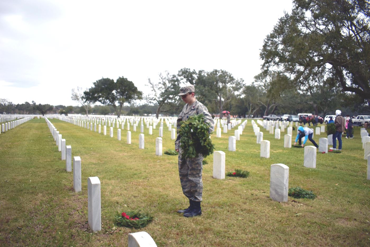 Cadet salutes after laying a wreath in honor of those who served. Rain or shine, we remember their dedication.