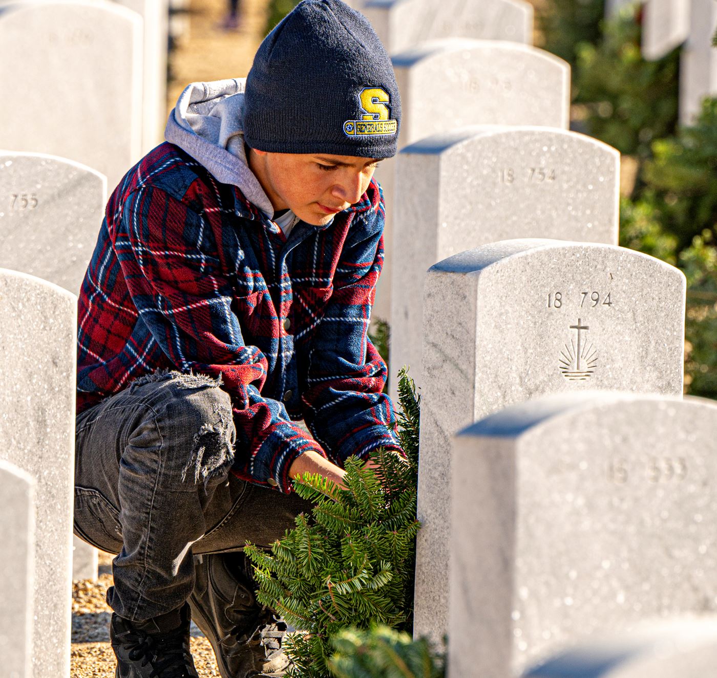 Young volunteer laying a wreath<br>