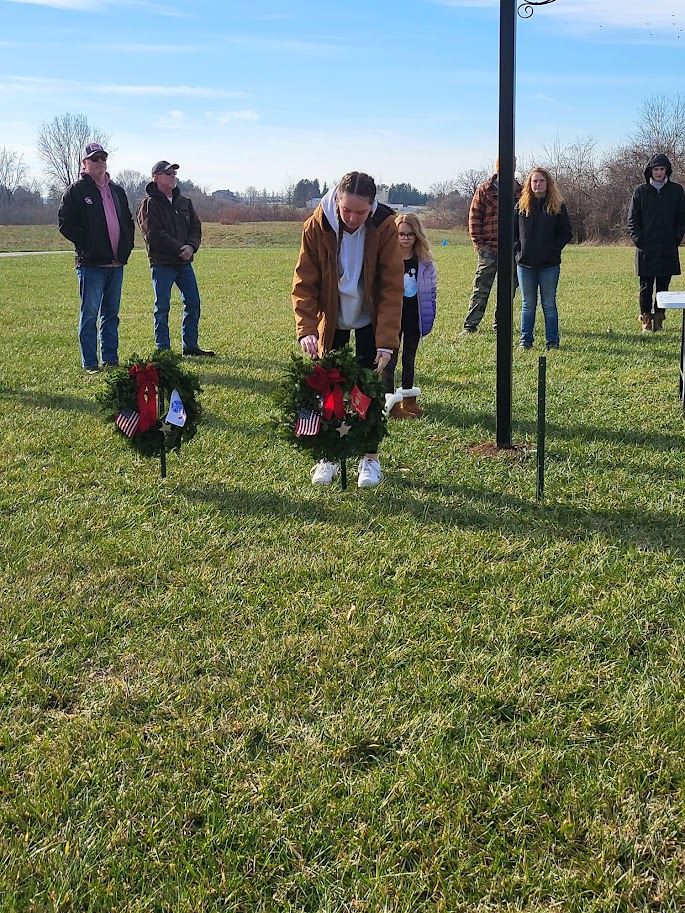 Kamber Mitchell presenting the Marine wreath