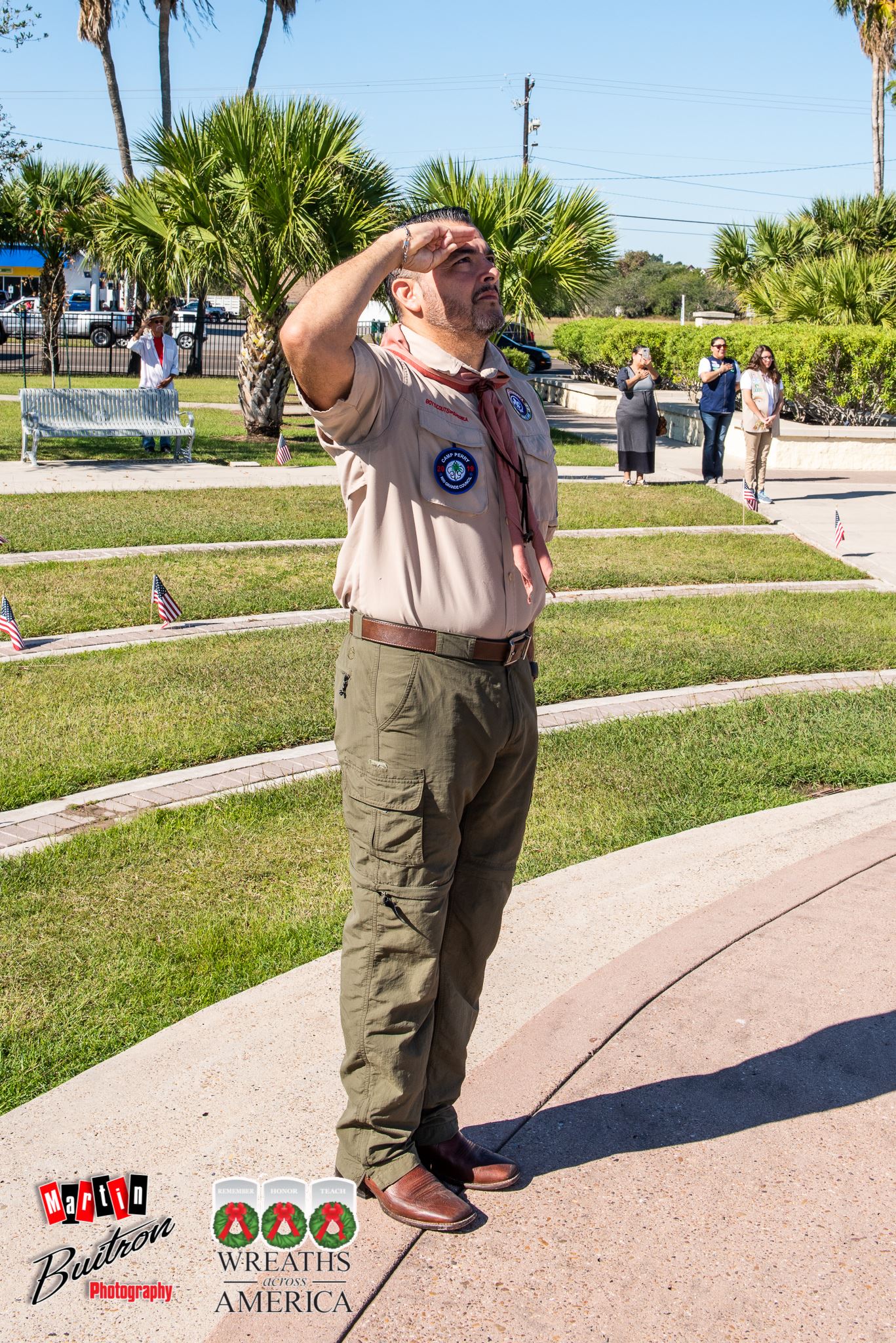 The Scouts leader shows his patriotism.  Leading by example