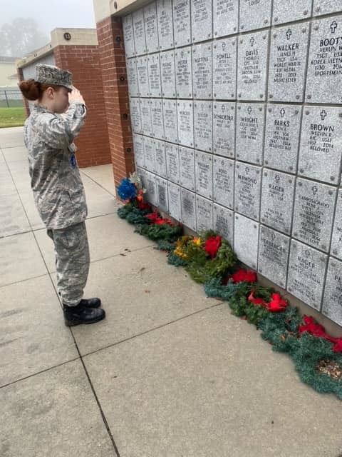 Cadet honors veterans at the columbarium, remembering their sacrifice and service.