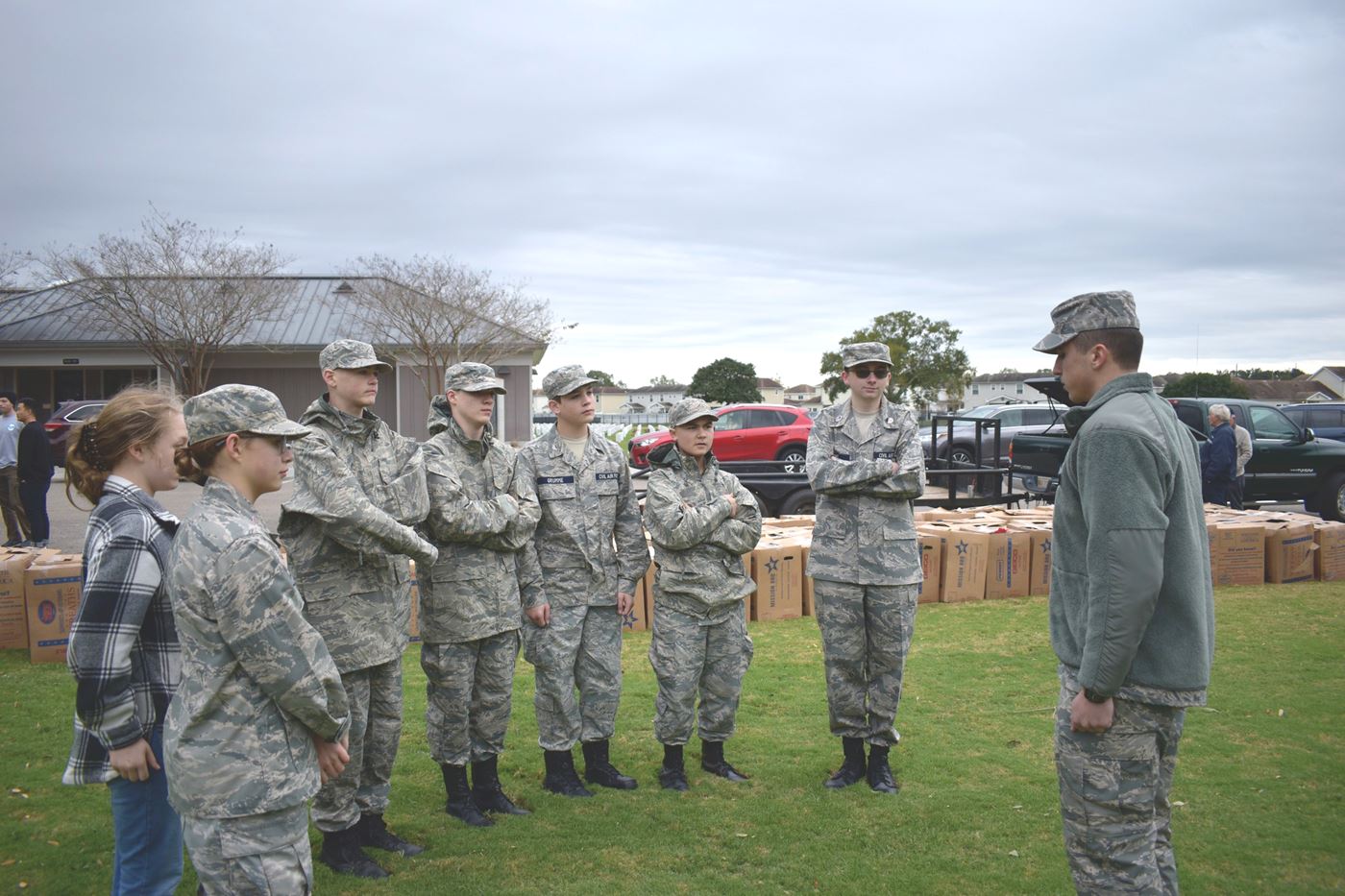 Cadets gather for final instructions, preparing to honor the fallen at Biloxi National Cemetery with respect and commitment.