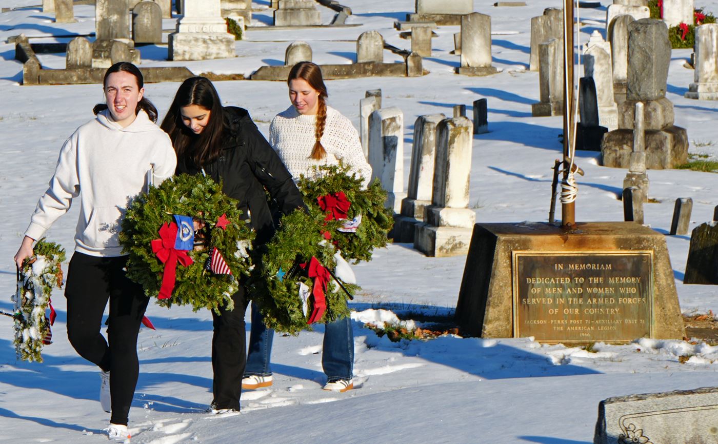 Ladies from ROTC retire the memorial wreaths.