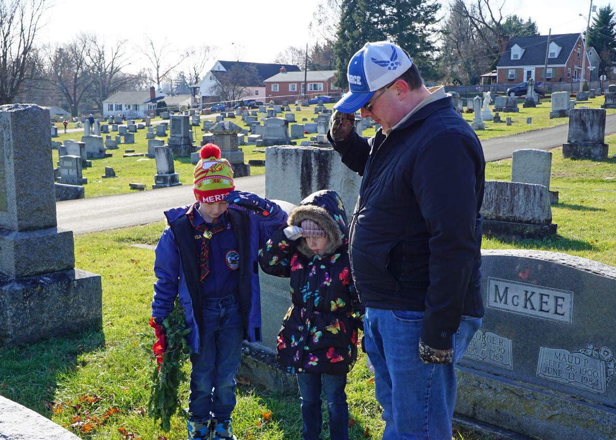 Parent showing his children what it is to Remember, Honor &amp; most importantly Teach.