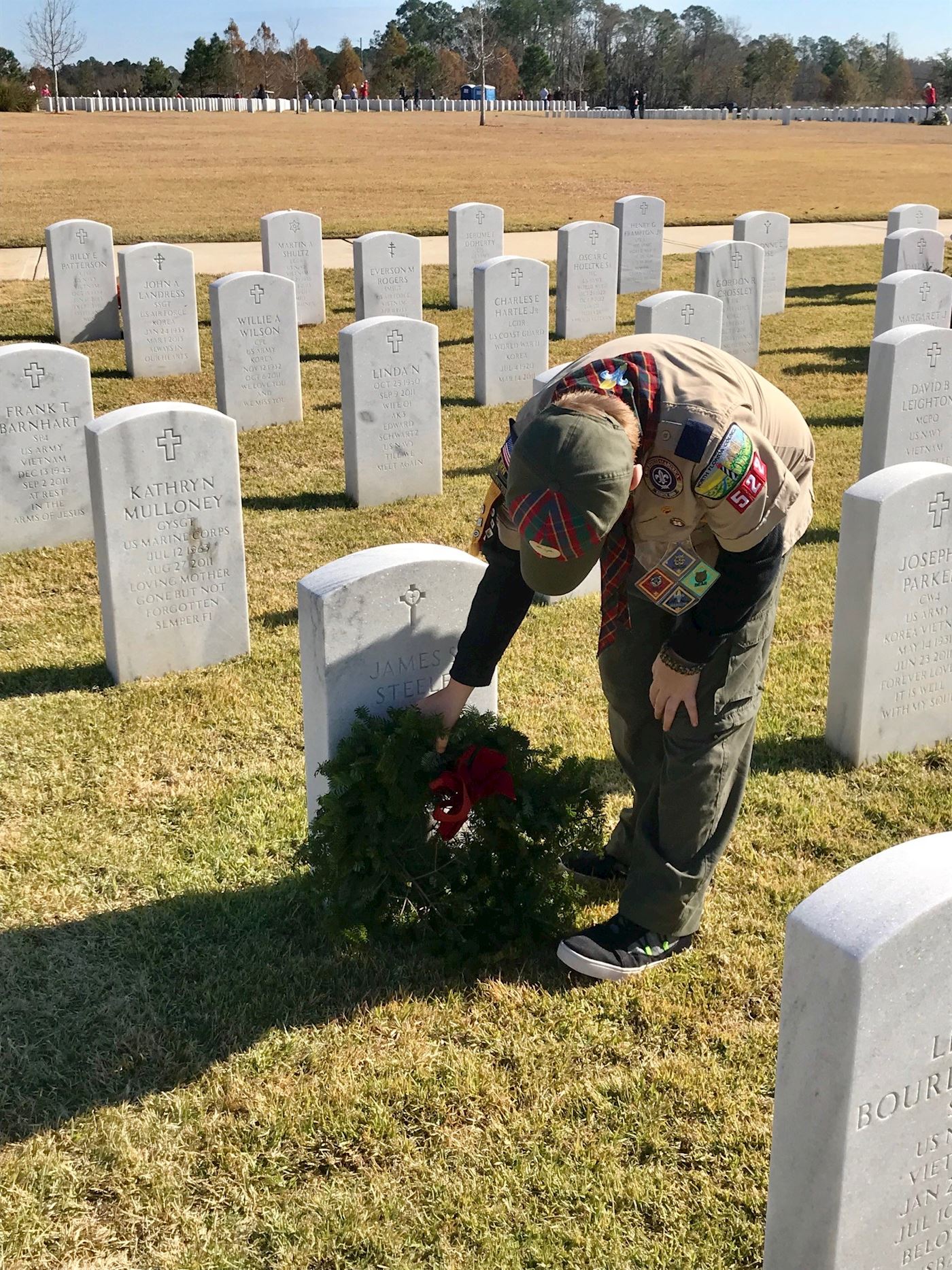 Conner Steele, Pack 522 Weblos, placing his Grandfather's wreath in Section 7