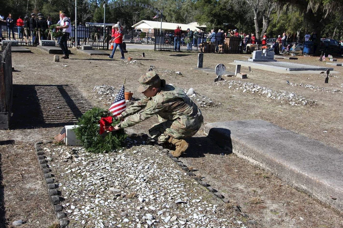 Soldier Placing Wreath on Family Member Grave