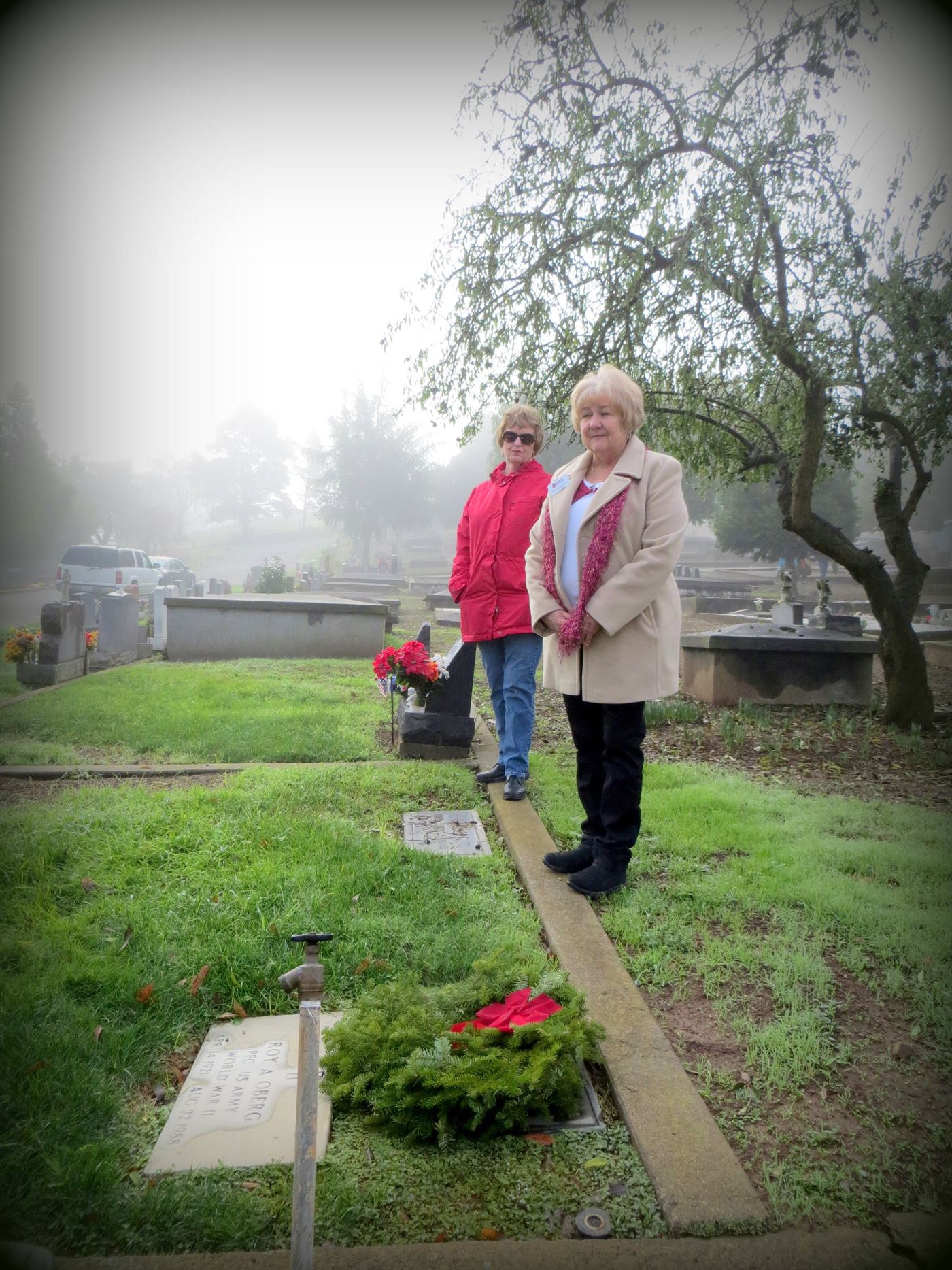 Kris Hernandez and cousin Jackie Berryhill lay wreaths on family veteran gravesites