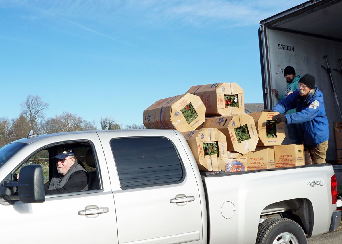 Unloading Wreaths from Tractor Trailer to Pickup to transport to storage garage.