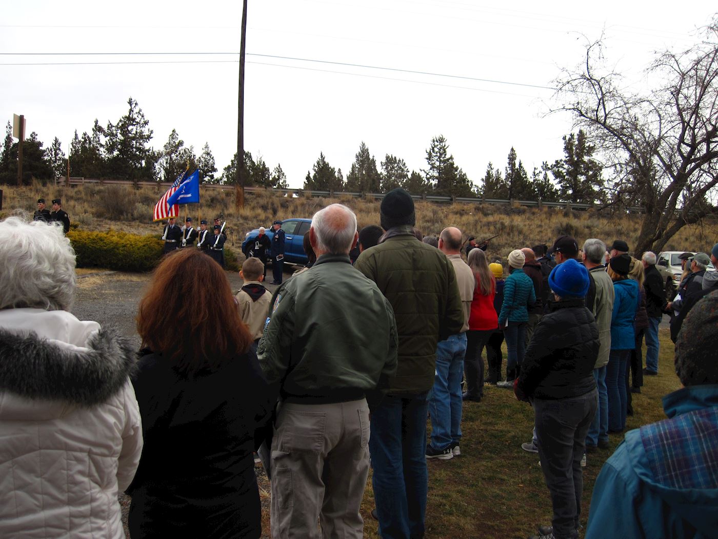 Gathering to honor raising and lowering of the flag before wreath laying.