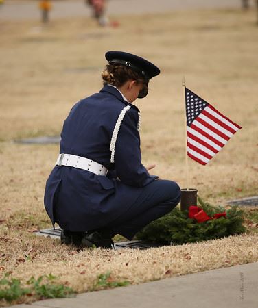 Cadet 1st Lt Jordan Phillips, Civil Air Patrol Lakeshore Squadron, places a wreath on her grandfather's grave.

Photo credit: Teri Myers
