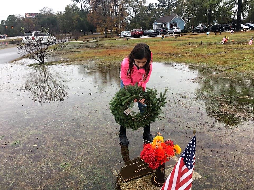 The daughter of the Squadron Commander for the Grand Strand Composite Squadron is pictured laying a wreath at the grave-site of a US Army Veteran who is interned at North Myrtle Beach Memorial Gardens.