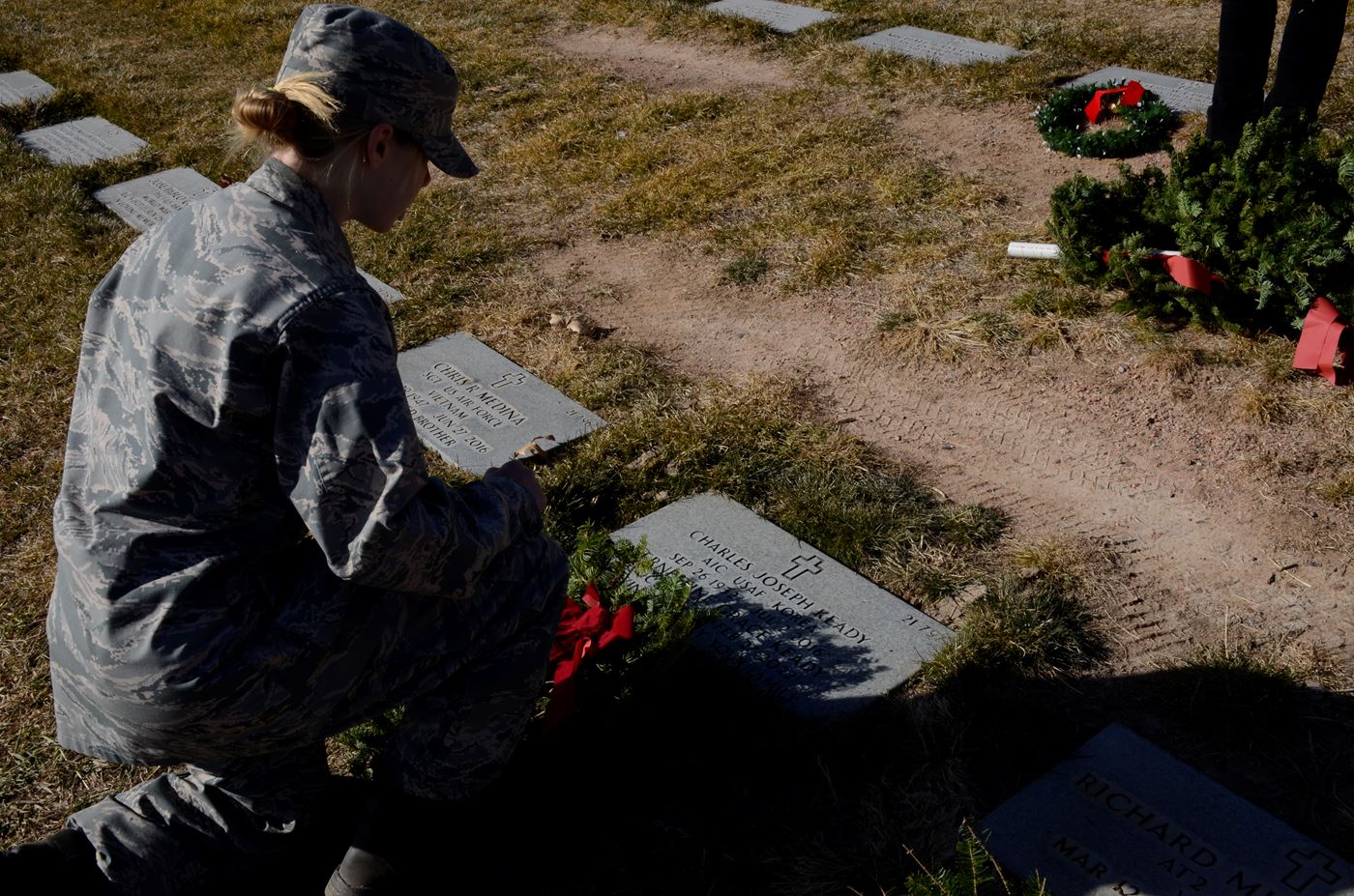 Taos Cadet reads the name of Charles Joseph Keady, Airman First Class, USAF - Korea and his wife Ernestine Grace Keady. "Loving Memory" - Your Family