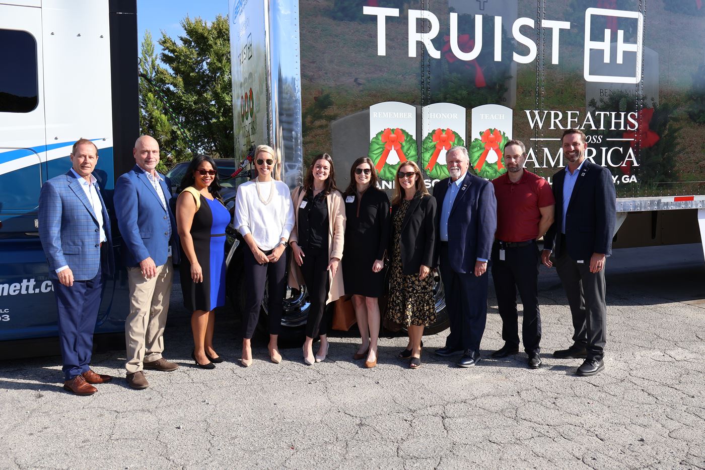 Members of Bennett and Truist Stand in Front of Cobranded WAA Trailer