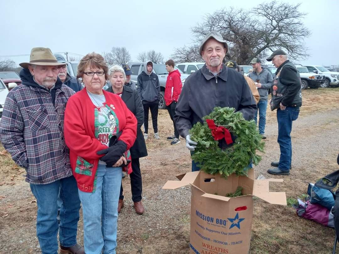 Even in the cold weather, volunteers lined up to help place the wreaths<br>