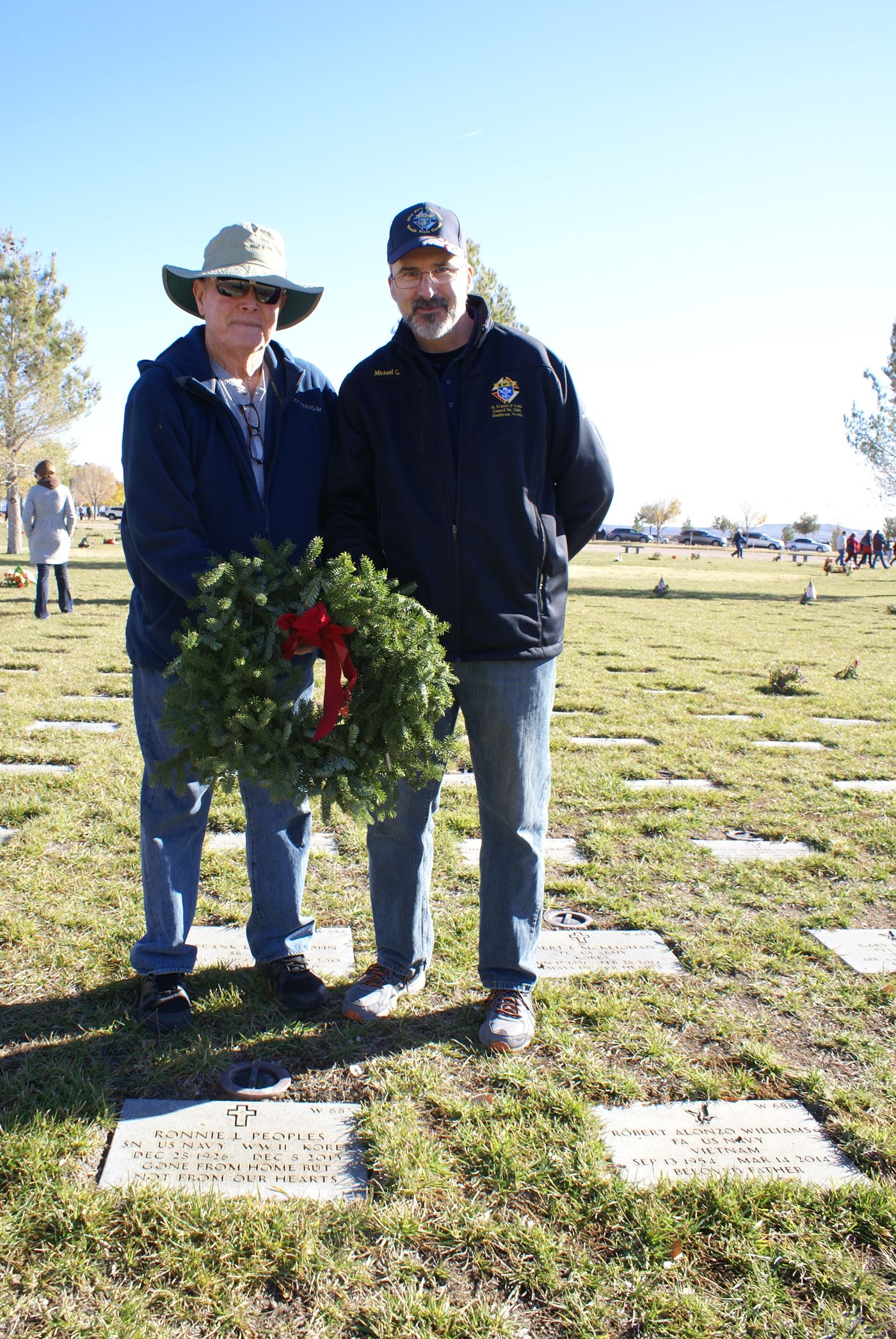 SK's Tom Edwards and Mike Gagnon  lay a wreath on a family members gravesite