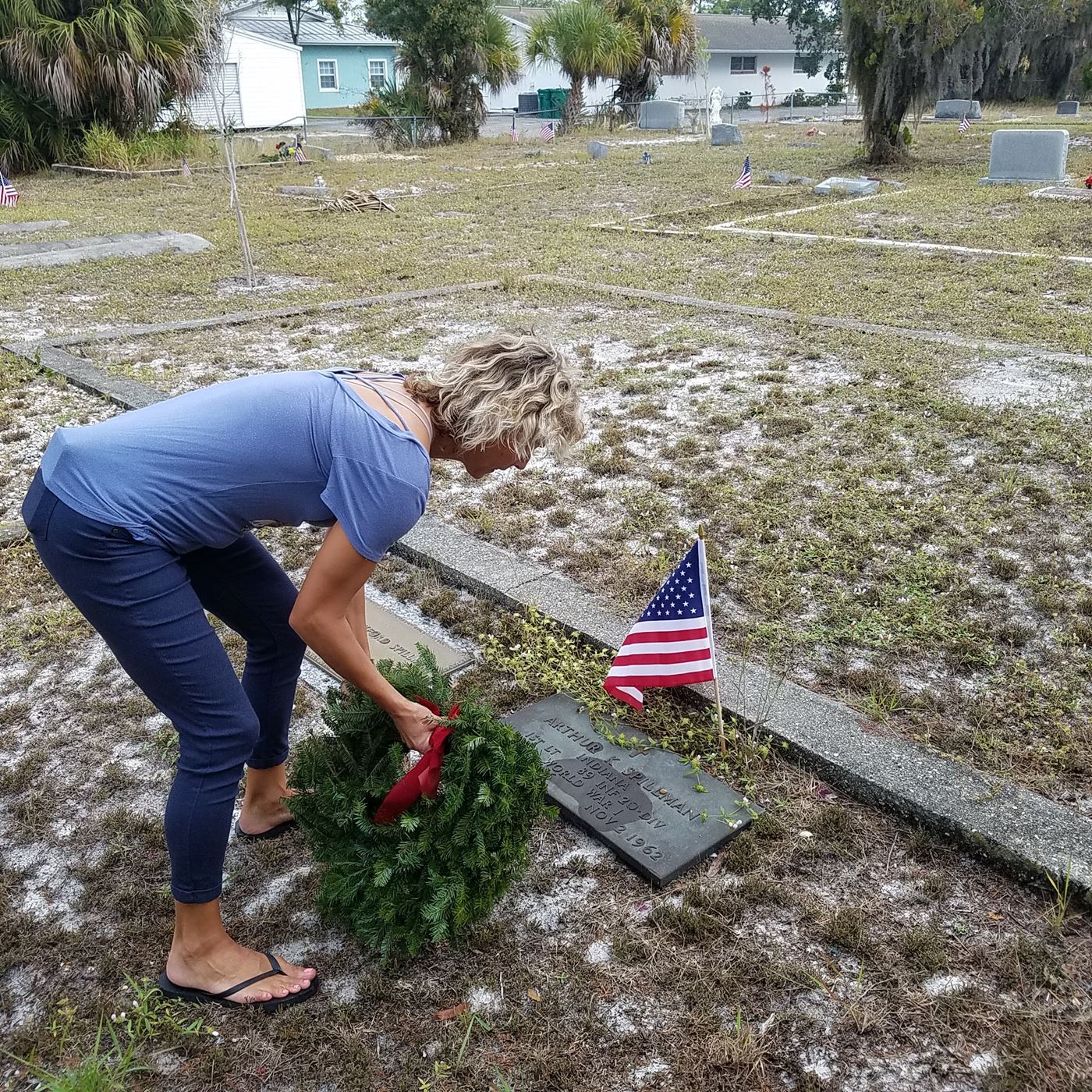 A volunteer places a wreath.