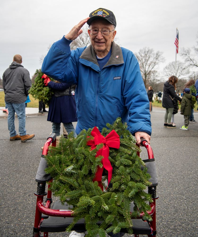 Despite being in a walker, he carried the wreaths to place for the veterans