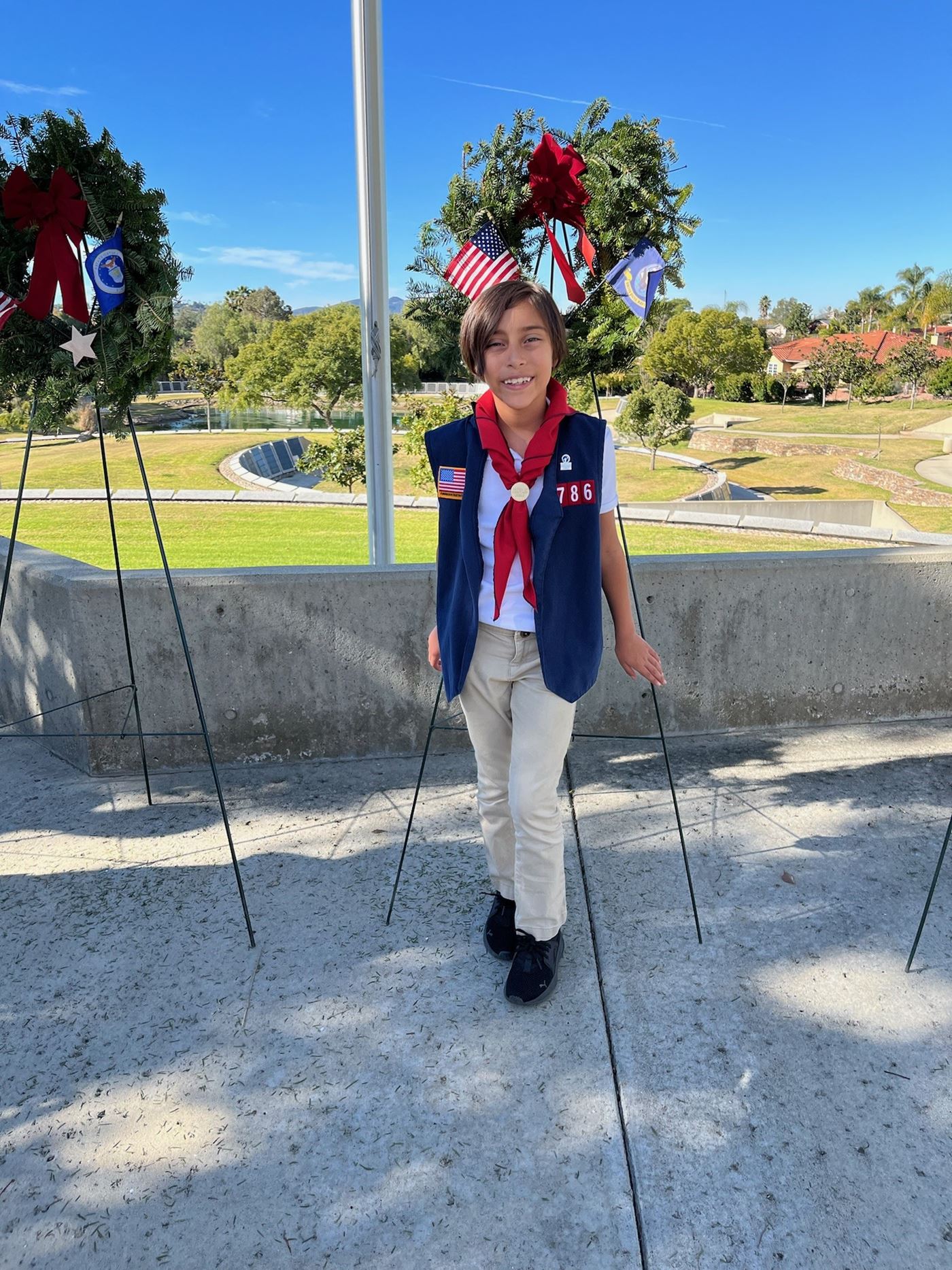 Sofia standing in front of the Navy Wreath after the ceremony