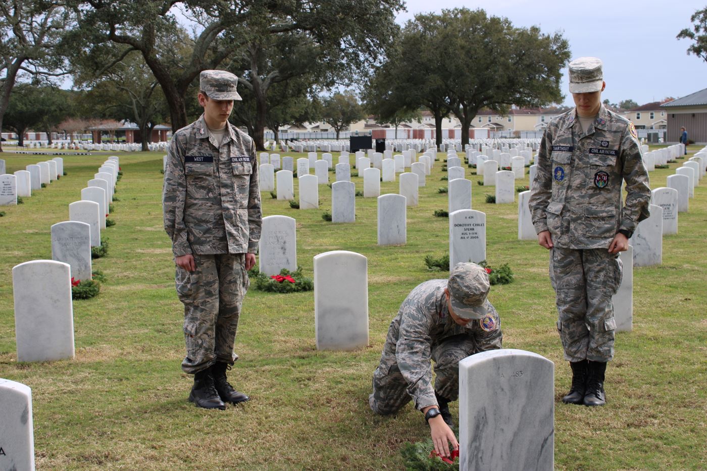 In a moment of reverence, Cadets West, Hinkle, and Swarthout perform a salute, remembering those who gave the ultimate sacrifice.