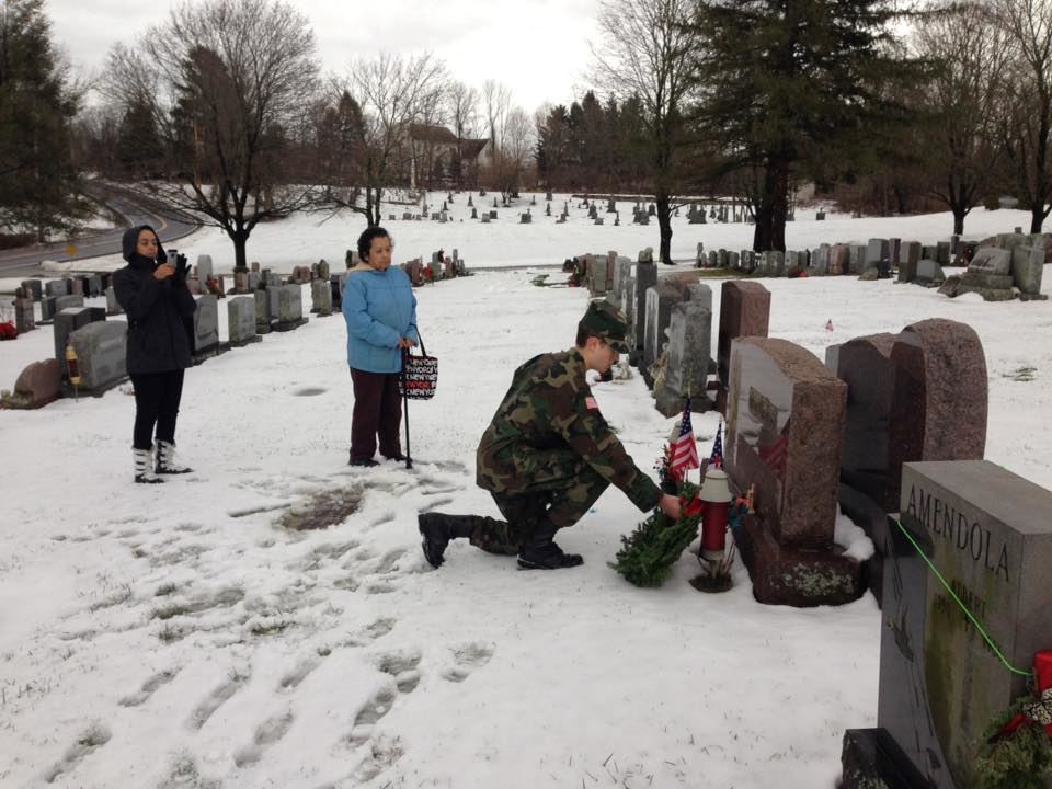 WA 2016 - Placing a wreath on a veteran's grave with family members.